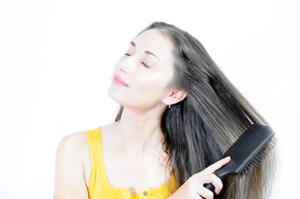 Young woman is combing — Stock Photo, Image