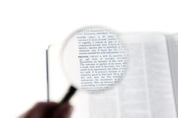 A magnifying glass on the word achievement — Stock Photo, Image
