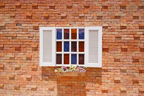 White window with flower pots on the brick wall. — Stock Photo, Image