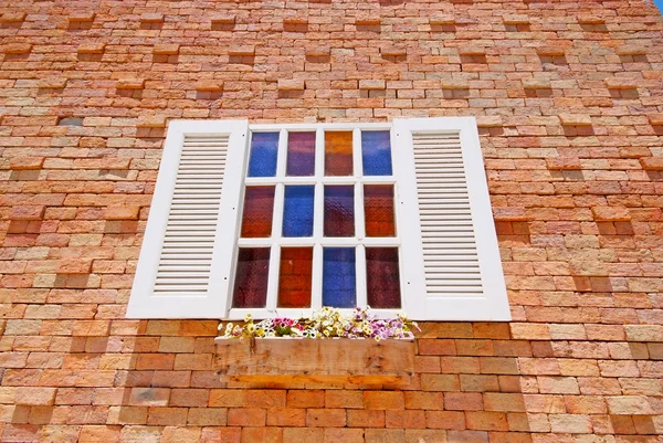 White window with flower pots on the brick wall. — Stock Photo, Image
