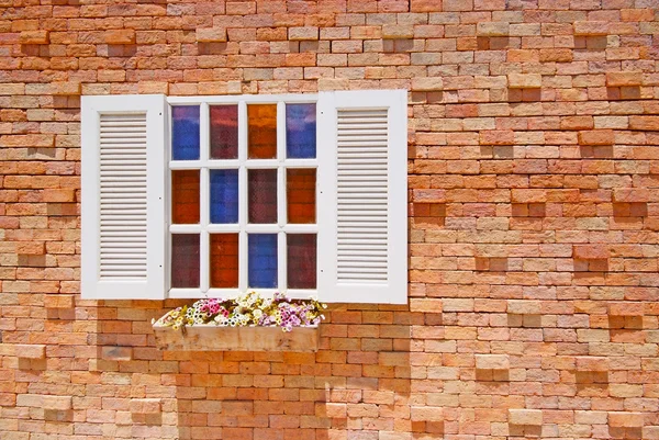 White window with flower pots on the brick wall. — Stock Photo, Image