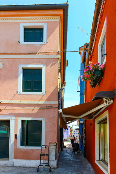 BURANO ISLAND, VENICE, ITALY - JULY 4, 2022: Colorful house in Burano island, Venice, Italy. Famous travel destination.