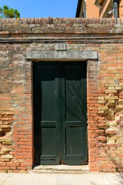 Old wooden door in a house in burano Island, Ital