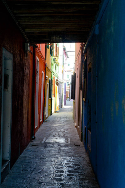 An alley street in Burano Island, Venice, Italy