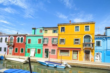 BURANO ISLAND, VENICE, ITALY - JULY 4, 2022: Colorful houses on the canal in Burano Island. Famous travel destination.