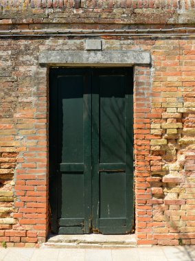 Old wooden door in a house in burano Island, Ital