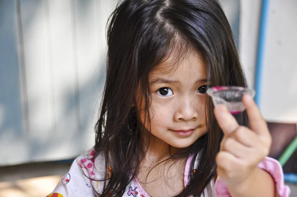 Little Asian girl making jelly. — Stock Photo, Image