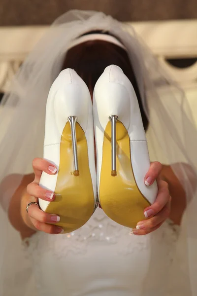 Holding shoes in her hands Stock Photo