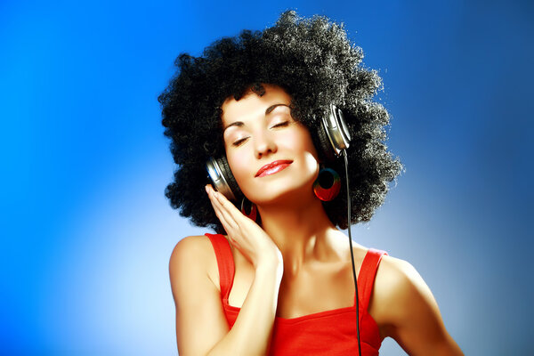 Beautiful woman wearing headphones enjoying the music