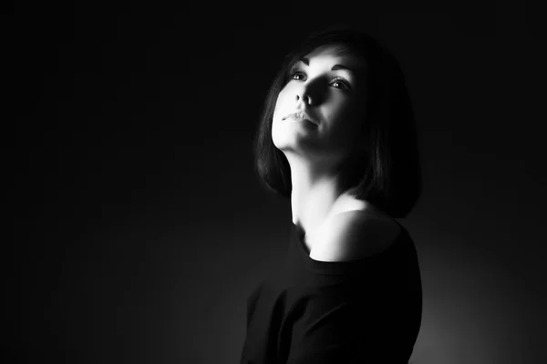 Beautiful woman with naked shoulder looking up. Black and white portrait. — Stock Photo, Image