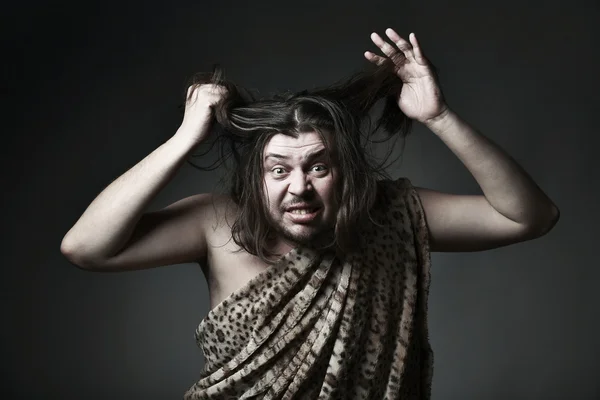 Wildman in leopard skin touch hair — Stock Photo, Image