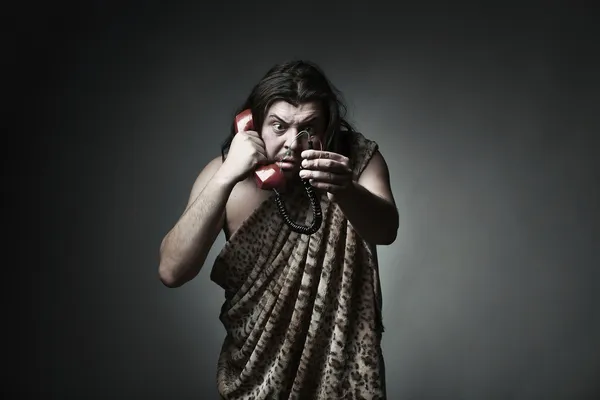 Wildman in leopard skin use retro telephone — Stock Photo, Image