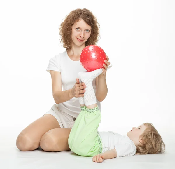 Happy mother doing sport exercises with little daughter — Stock Photo, Image