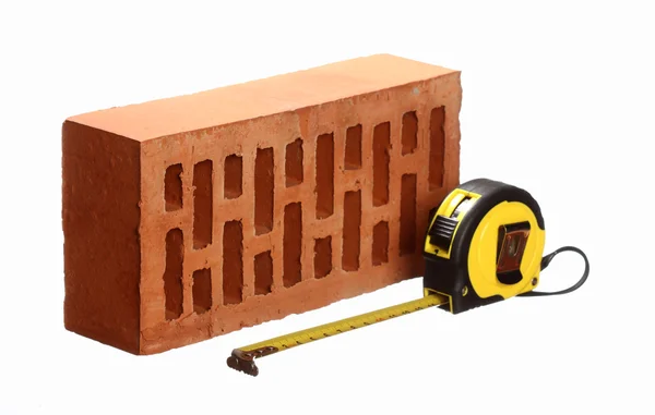 Brick and tape measure — Stock Photo, Image