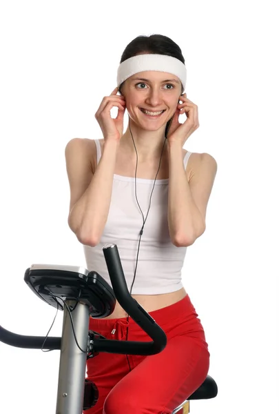 Happy young woman on a training bicycle — Stock Photo, Image