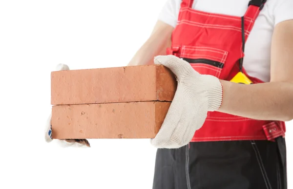 Builder in uniform holding bricks — Stock Photo, Image