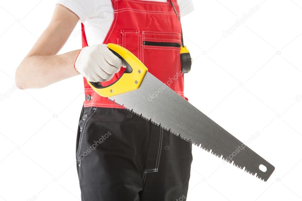 Construction worker in uniform with saw
