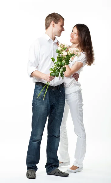 Data: cara apresentando flores para jovem senhora — Fotografia de Stock