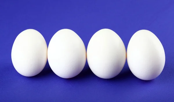 Eggs isolated on purple background — Stock Photo, Image