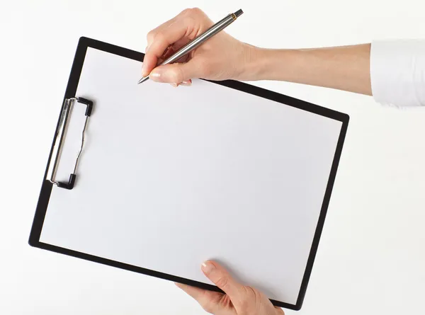 Human hand writing on a clipboard — Stock Photo, Image