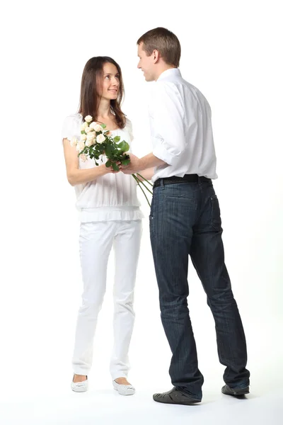 Romantic date: guy presenting flowers to young lady — Stock Photo, Image