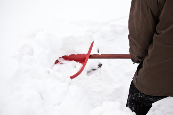 Man removing snow with a shovel