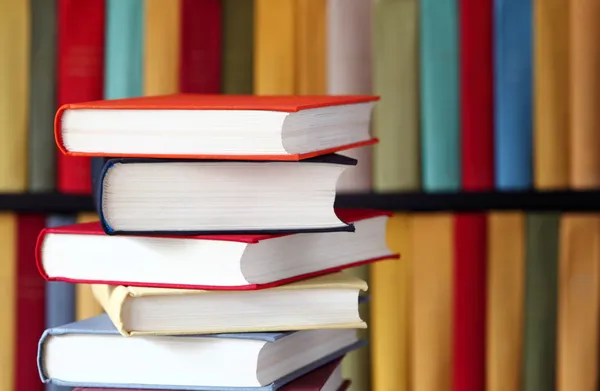 Stacked books and bookshelves — Stock Photo, Image