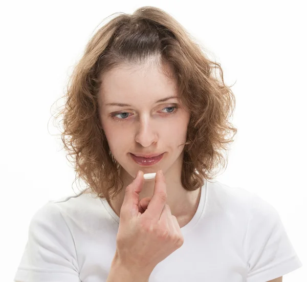 Attractive girl eating tablet — Stock Photo, Image