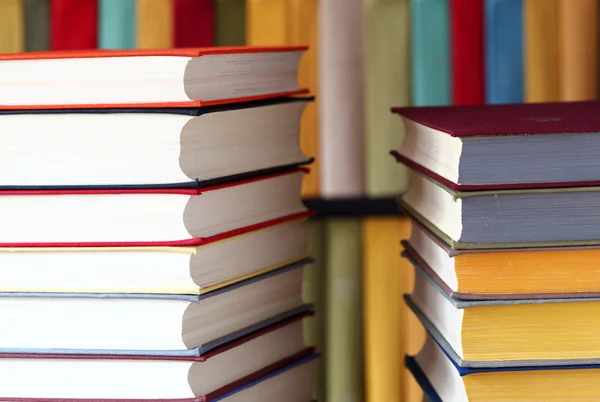 Stacked books and bookshelves — Stock Photo, Image