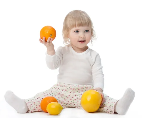 Happy baby with tasty fruits — Stock Photo, Image