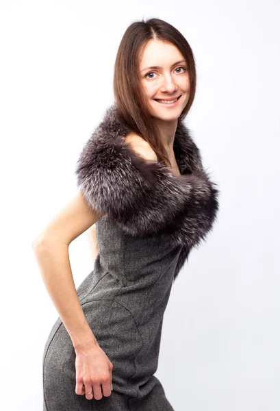 Beautiful smiling young brunette in dress with fur — Stock Photo, Image
