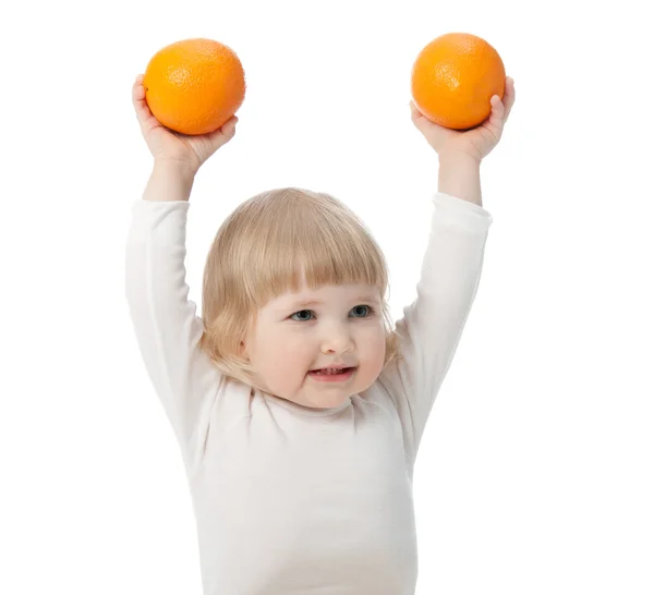 The baby girl with oranges — Stock Photo, Image