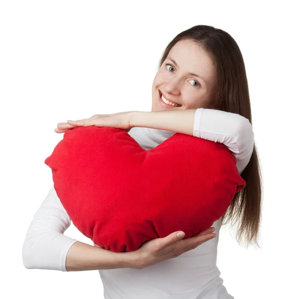 Attractive smiling brunette girl holding big red heart Stock Photo