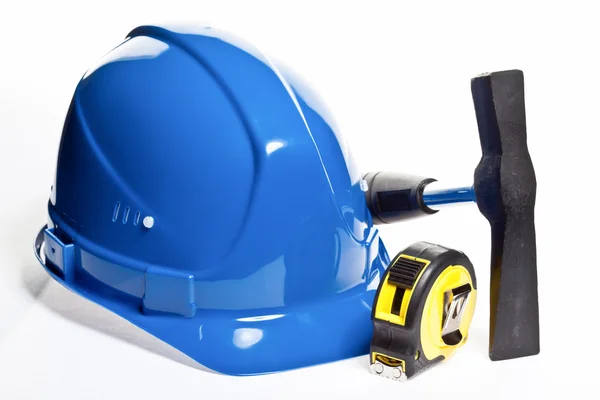 Hammer, tape line and blue hardhat — Stock Photo, Image