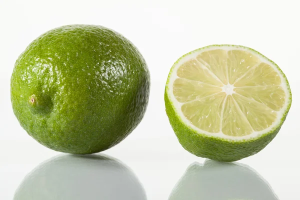 Whole lime and half of lime — Stock Photo, Image