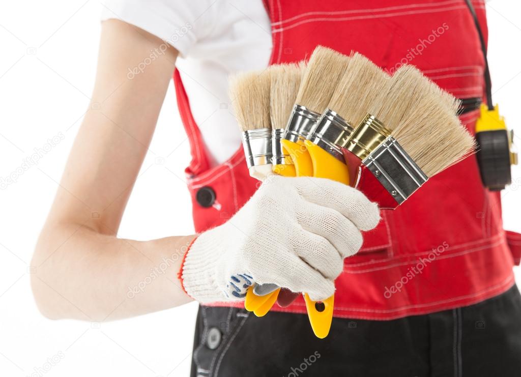 Construction worker in uniform with brushes