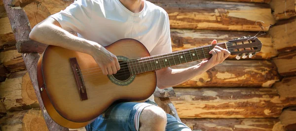 Boy touching the strings of a guitar — Stock Photo, Image