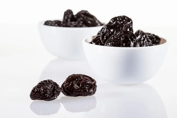 Prunes in white bowls — Stock Photo, Image