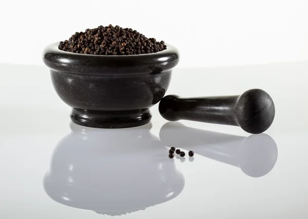 Pimentas pretas em um pote de barro — Fotografia de Stock