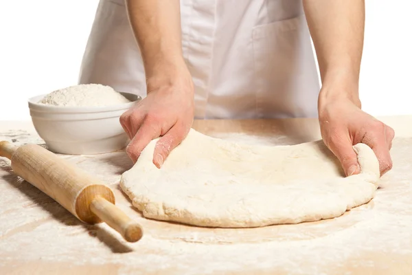 Hands stretching dough — Stock Photo, Image