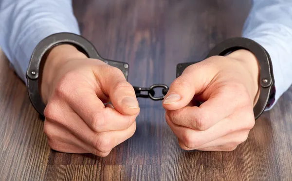 Hands in handcuffs Stock Photo