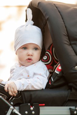 bir perambulator oturan kız bebek