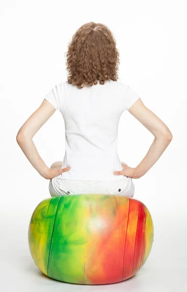 Young woman sitting on a gymnastic ball — Stock Photo, Image