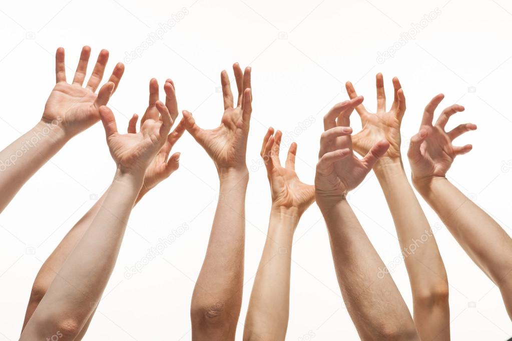 Many hands reaching out up