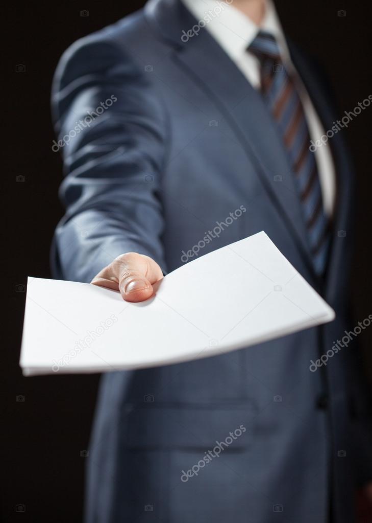 Businessman giving documents to you