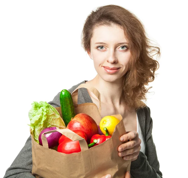 Smiling young woman with vegetables and fruits in shopping bag — Stock Photo, Image