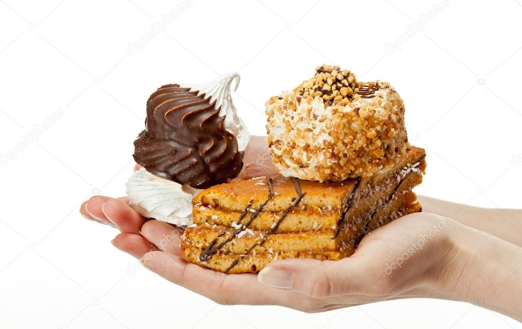 Hands holding delicious sweet cakes