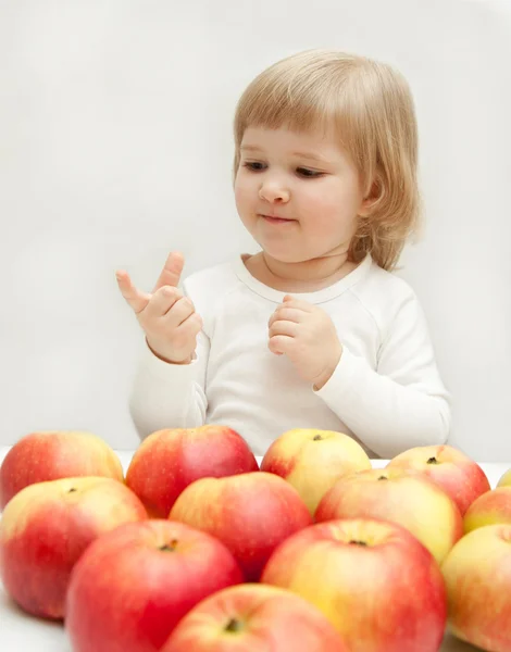 The girl is counting apples. — Stock Photo, Image