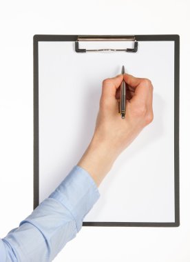 Human hand writing with pen on clipboard