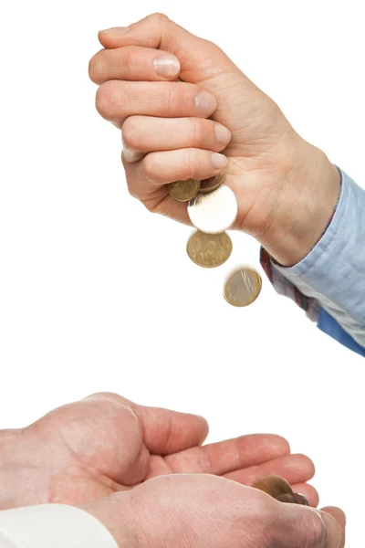 Pouring coins into hands — Stock Photo, Image